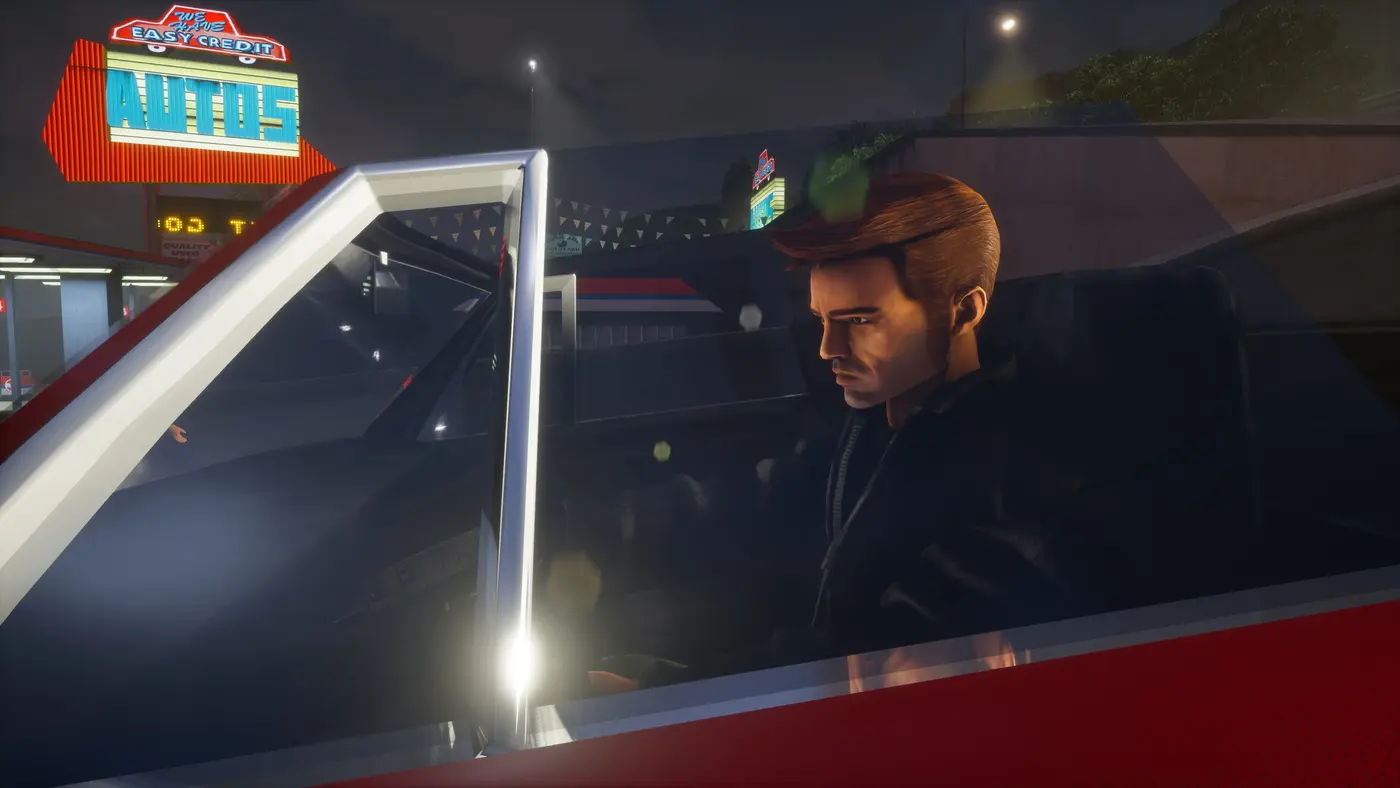 Claude, the silent protagonist of GTA 3, dark-haired in a dark jacket, behind the wheel of a car at night in front of a Liberty City dealership lit with red and blue neon