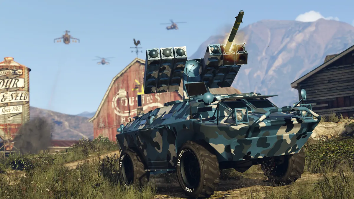GTA Online screenshot: a camouflaged APC armored vehicle fitted with a missile launcher in front of a barn, attack helicopters in the sky