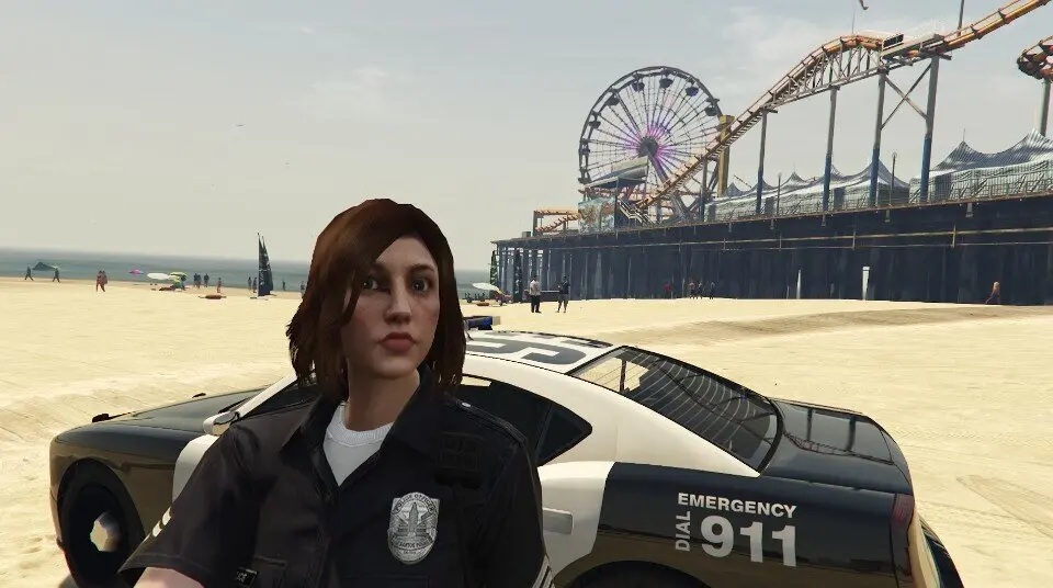 GTA 5 screenshot with LSPDFR: a uniformed female officer poses in front of her black-and-white patrol car parked on the beach, with the pier's Ferris wheel and roller coaster in the background
