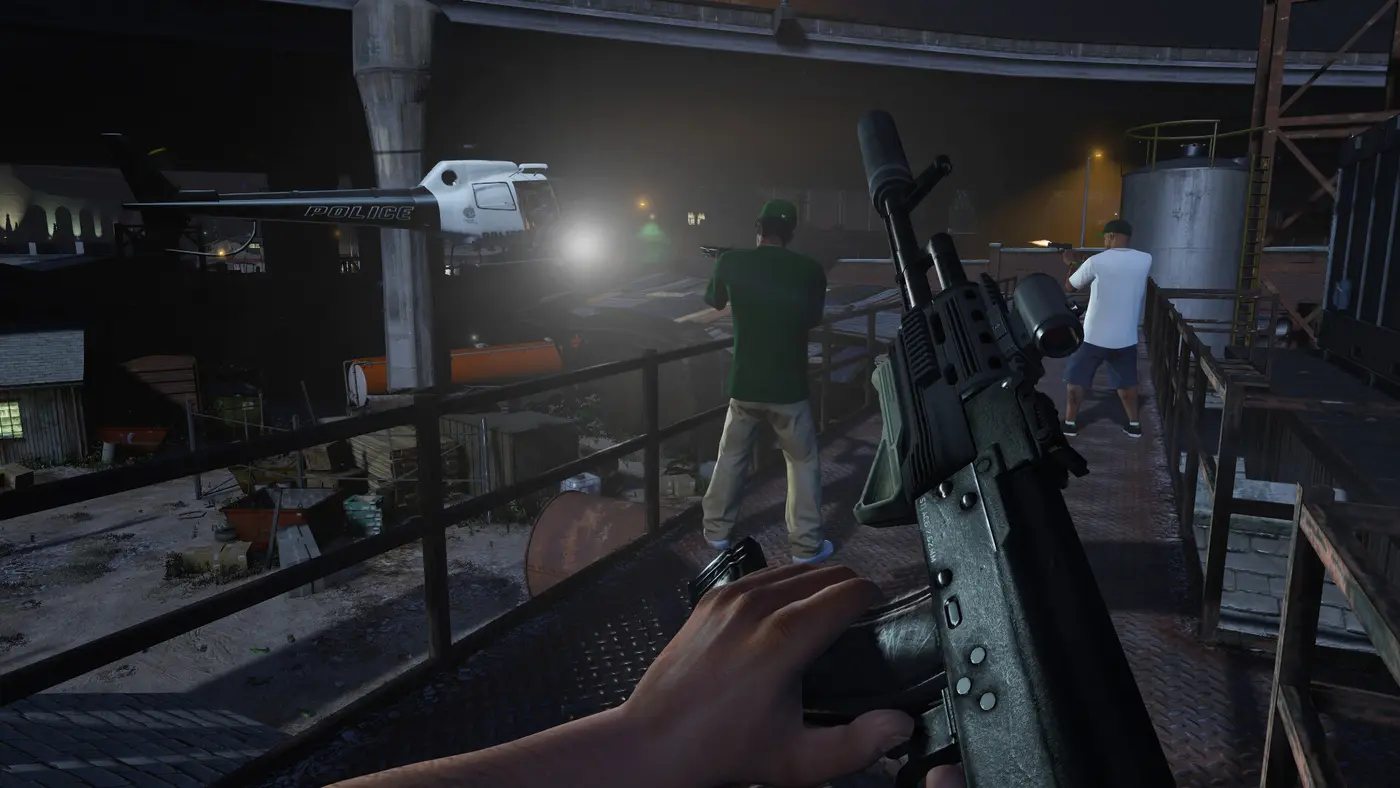 GTA V screenshot in first-person view: a suppressed assault rifle held with both hands on a metal catwalk at night, next to two armed men firing at a police helicopter whose searchlight sweeps the catwalk