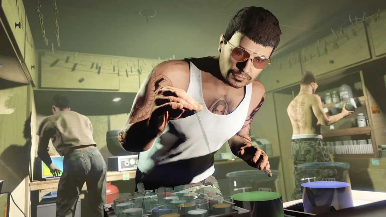A GTA Online character in a white tank top, sunglasses, and tattooed arms handles a pipette over a rack of colorful chemical samples in a makeshift lab, two associates busy around him