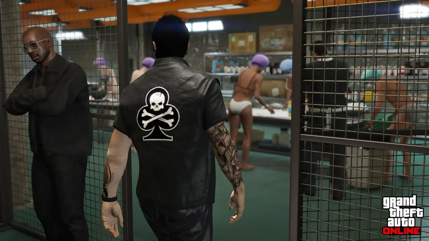 Inside a GTA Online cocaine lab, a Motorcycle Club member in a leather vest watches from behind a wire fence as workers in underwear and hairnets package the product on workbenches