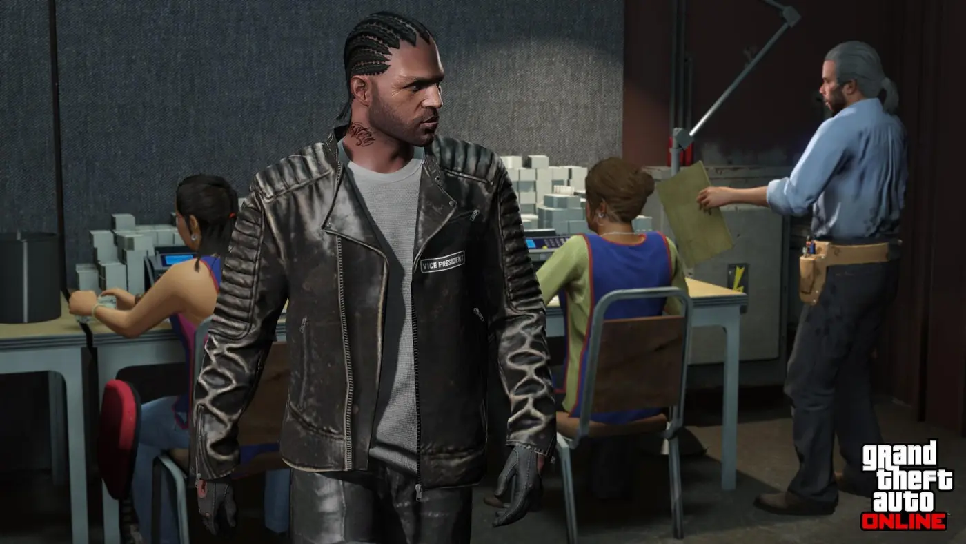 In a GTA Online counterfeit cash factory, a club member in a jacket stamped 'Vice President' stands in front of workers printing and bundling stacks of dollars on presses