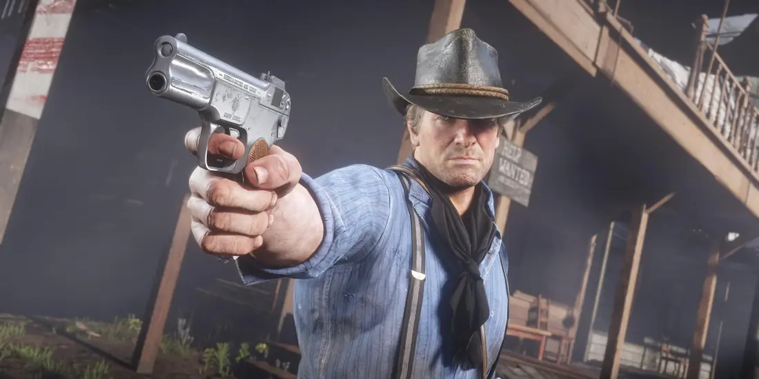 Close-up of Arthur Morgan, cowboy hat and blue shirt, aiming a pocket pistol in Red Dead Redemption 2, with highly detailed rendering of the face and hands