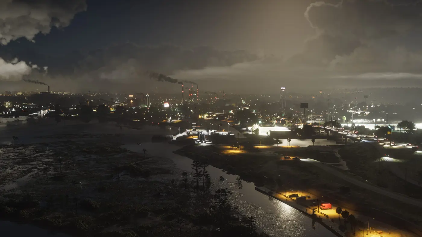 Aerial night view of Ambrosia in GTA VI: factory smokestacks belching smoke above a lit-up industrial town, dark swamps in the foreground, and a highway lined with streetlights