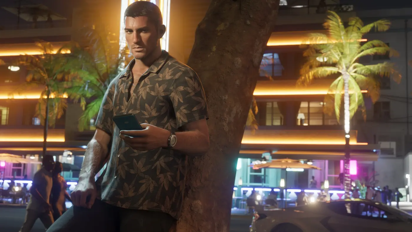 Jason Duval at night in Vice City, wearing a botanical-print shirt, holding a phone, leaning against a tree in front of a gold-lit neon building lined with palm trees
