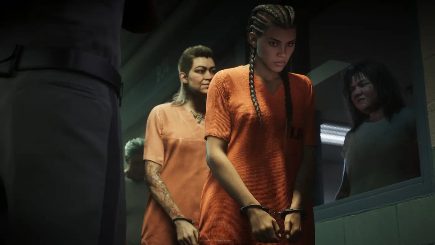 Lucia Caminos in an orange inmate jumpsuit, handcuffed and escorted down a penitentiary hallway, two other female prisoners around her