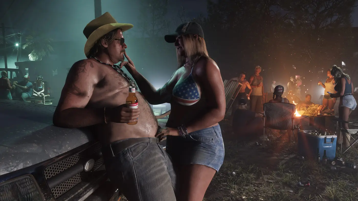 A nighttime bonfire party in the Leonida backcountry: a shirtless man in a cowboy hat, a woman in a US-flag top and a crowd of revelers near the blaze in GTA VI