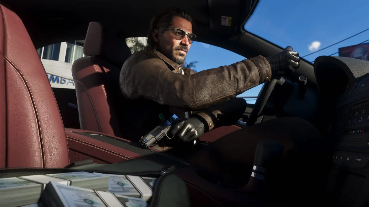 Raul Bautista in GTA 6, a man with glasses and a ponytail in a leather jacket and black gloves, sitting behind the wheel of a car, a pistol and wads of cash beside him in broad daylight