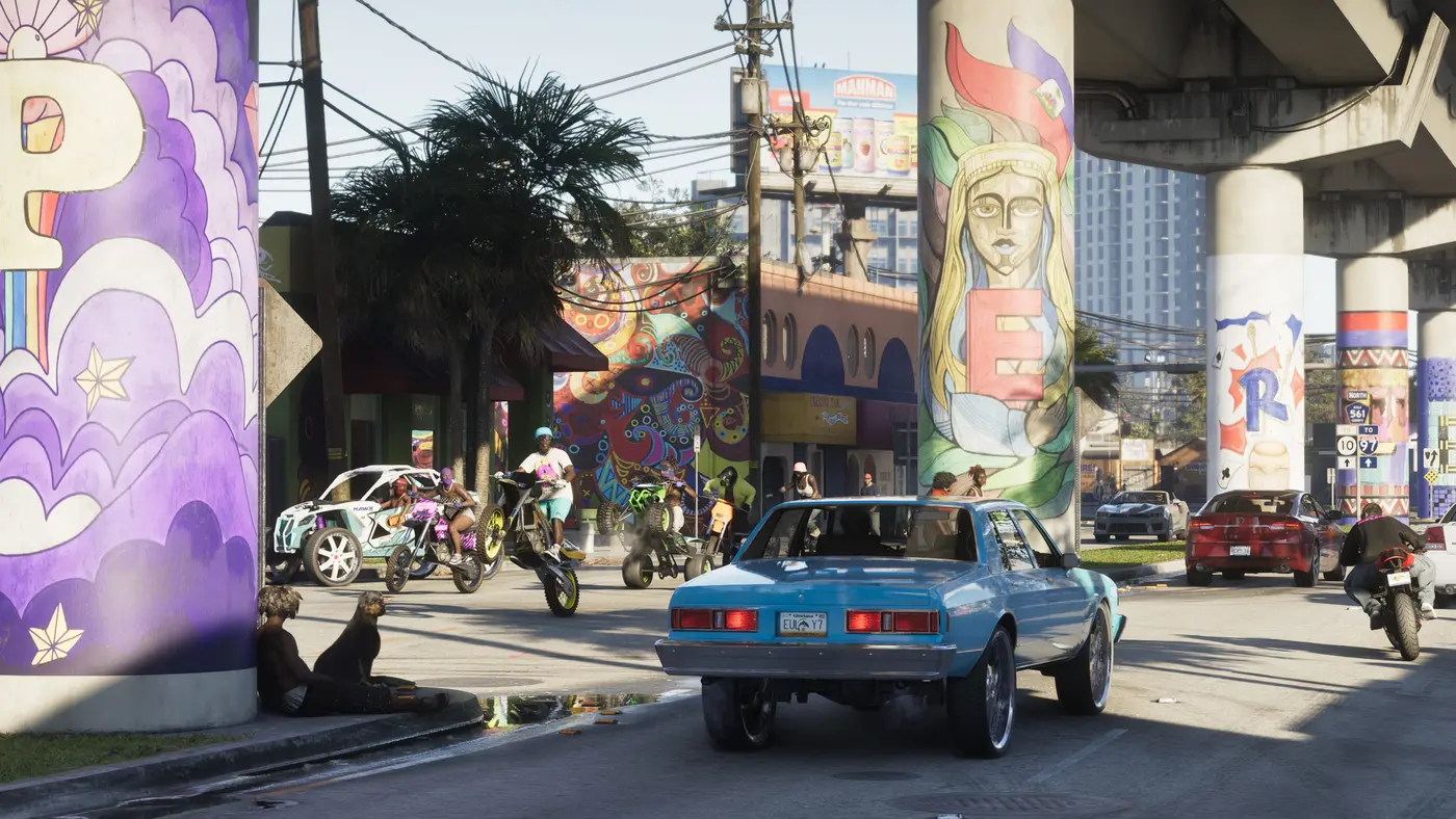 Vice City street in GTA VI under a painted highway overpass: a blue lowrider sedan from behind, motorcycles and an off-road buggy in the background, cars parked along the sidewalk