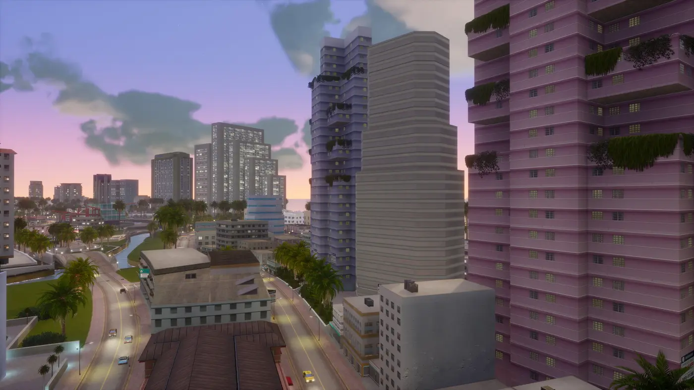High-angle view of the Vice City skyline at dusk, pastel skyscrapers, palm trees and a coastal avenue under a pink and purple sky, in GTA Vice City